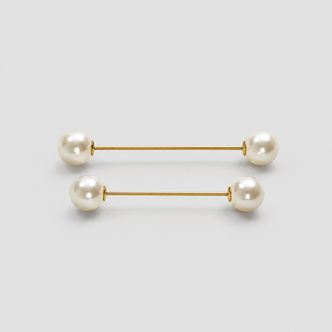 A pair of gold bar earrings with white pearl beads at each end, displayed on a clean light gray background.