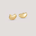 A pair of polished gold shaped stud earrings on a light gray background.