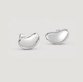 A pair of polished silver shaped stud earrings on a light gray background.