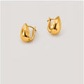 A pair of polished gold huggie hoop earrings with a teardrop-shaped, faceted design, displayed on a light gray background.