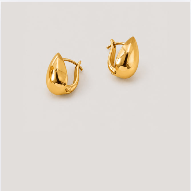 A pair of polished gold huggie hoop earrings with a teardrop-shaped, faceted design, displayed on a light gray background.