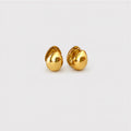 A pair of small, polished gold stud earrings shaped like stylized teardrops or leaves, displayed on a clean, light gray background.